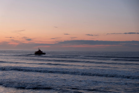 Orange sunset over a dark blue seaの写真素材