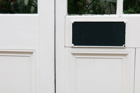 White Door With Blank Black Signの写真素材