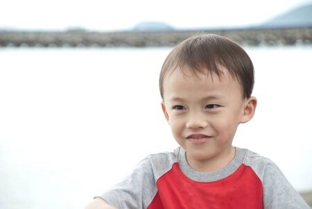 asian kid portrait in differnt emotion outdoorの写真素材