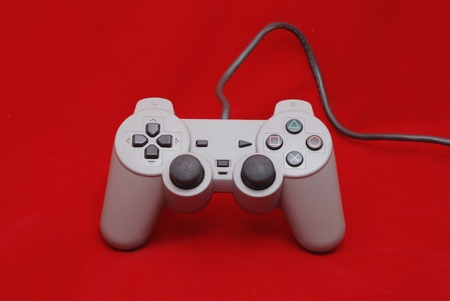 single white joy stick on red background