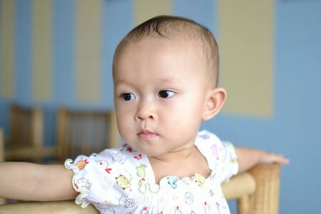 a cute young asian baby in daily activity.