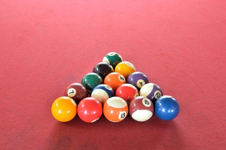 set of nine ball on red floor.
