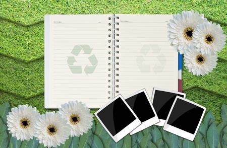 opened blank notepad on grass background.の写真素材