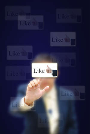 Businessman touching virtual screen on dark background.