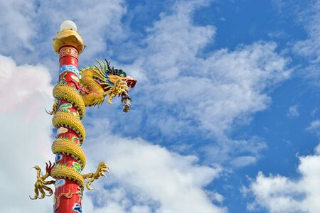 Dragon pilr in chinese temple against blue sky.の写真素材