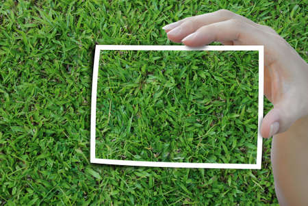 woman hand holding frame of background photo.の写真素材