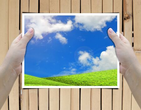 artwork of two hands holding picture frame.の写真素材
