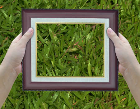 artwork of two hands holding picture frame.の写真素材
