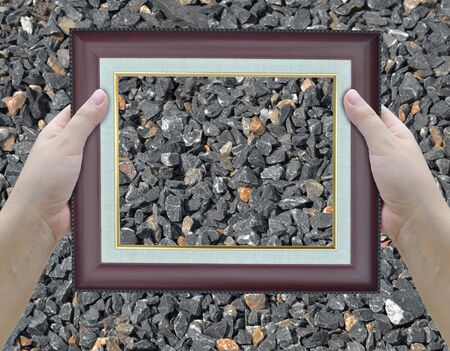 artwork of two hands holding picture frame.の写真素材