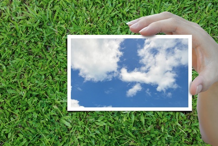 sky picture in woman hand over nice background.の写真素材