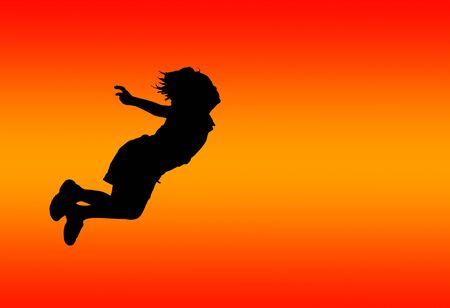 silhouette of jumping boy with sunset background.の写真素材