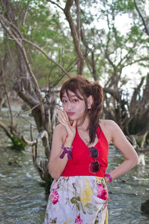 Cute young asian woman portrait on the beach.