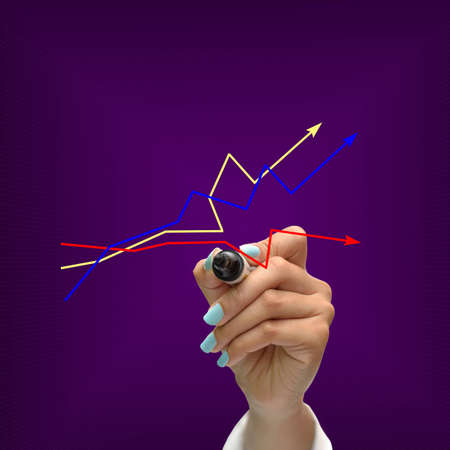 Business selection concept by black pen in hand on purple gradient background.の写真素材