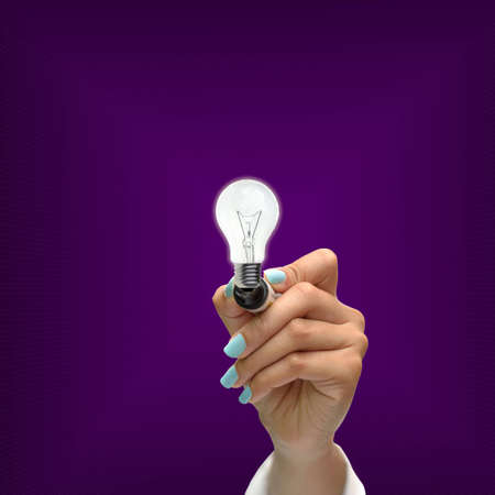 Business selection concept by black pen in hand on purple gradient background.の写真素材