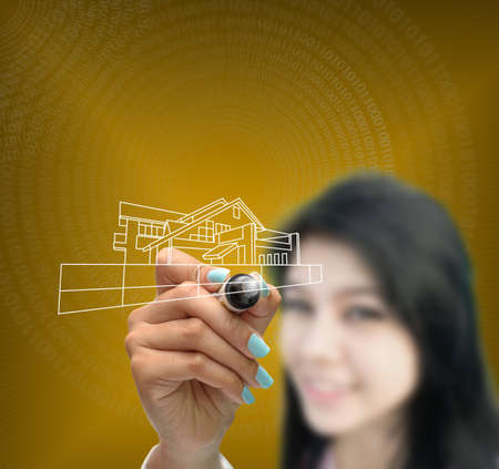 business selection concept by business woman writing business object on gradient yellow background.の写真素材