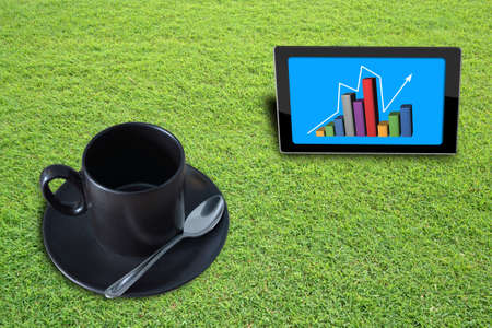 Empty Black coffee cup on grass field background.の写真素材