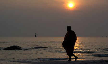 Early morning activity of monk on the beach at Huahin Thailand.のeditorial素材