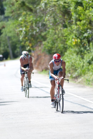 SAMUI, THAILAND - APRIL 22 2012: Samui triathlon 2012 event. Competitors in action during the triathlon on Sunday 22 April 2012 in Ko Samui island, Suratthani, Thailand.のeditorial素材