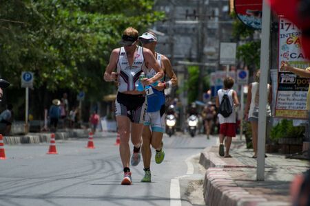 SAMUI, THAILAND - APRIL 22 2012: Samui triathlon 2012 event. Competitors in action during the triathlon on Sunday 22 April 2012 in Ko Samui island, Suratthani, Thailand.のeditorial素材