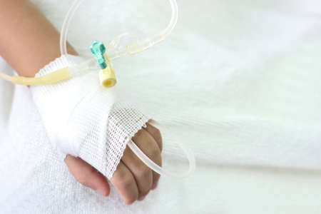Intra venous fluid line at left arm of boy patient.の写真素材