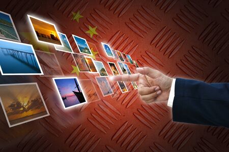 business hand selecting business icon on old China flag background.の写真素材