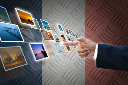 business hand selecting business icon on old France flag background.の写真素材