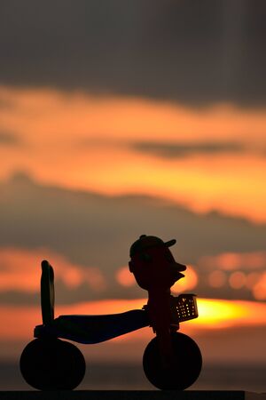Small bike for kid silhouette at dusk.の写真素材