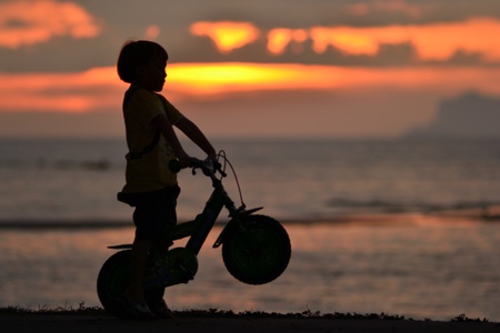 Small bike for kid silhouette at dusk.の写真素材