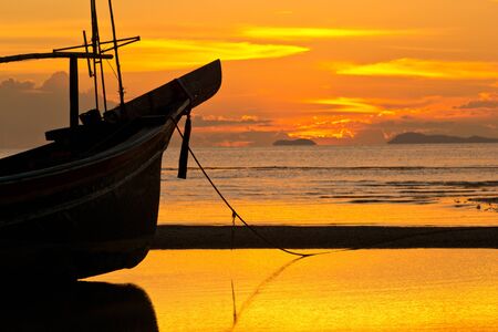Golden sky during sunset at the beach.の写真素材