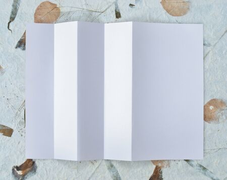Folded empty white paper on background.の写真素材