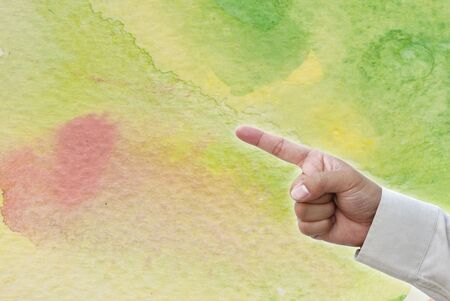 Hand pointing at business object on water color water art background.の写真素材