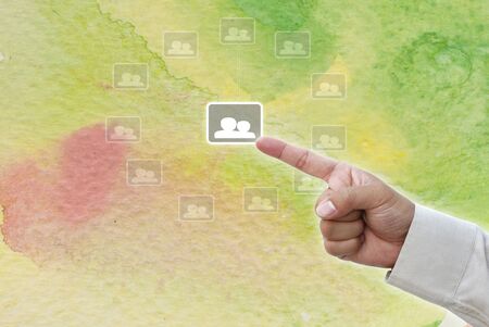 Hand pointing at business object on water color water art background.の写真素材