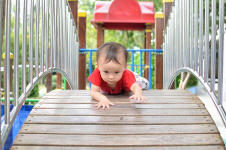 A small girl playing at the playground.の写真素材