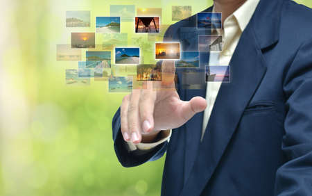 business hand selecting business icon on green abstract background.の写真素材