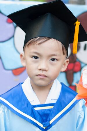 Asian boy in kindergarten graduate ceremony.の写真素材
