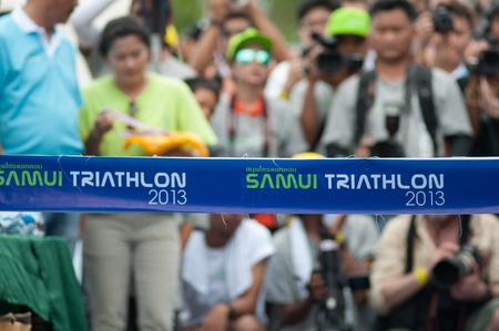 SAMUI, THAILAND - APRIL 21 2013: Samui triathlon 2013 event. Finish line and photographers background of the triathlon on Sunday 21 April 2013 in Ko Samui island, Suratthani, Thailand.のeditorial素材