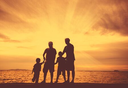 silhouette of happy family at the beach.の写真素材