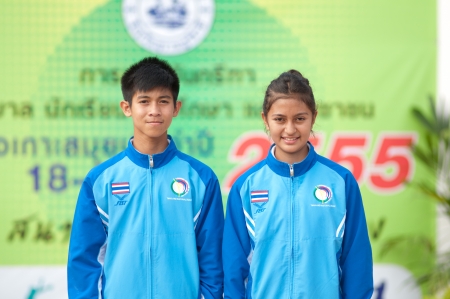 KO SAMUI,SURAT THANI - JULY 18 : Unidentified Thai students 4 - 7 years old with light torch in ceremony uniform during sport parade on July 18, 2012 in ko samui, Surat Thani, Thailand.のeditorial素材