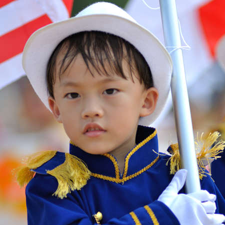 Cute asian six years old boy in bright blue shirt portrait.の写真素材
