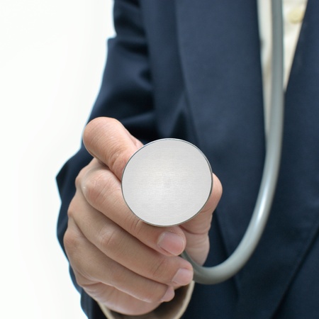 Business man with stethoscope on white background.の写真素材