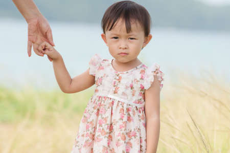 Cute asian girl  portrait in grass field.