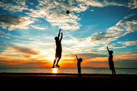 silhouette of family at dusk.の写真素材