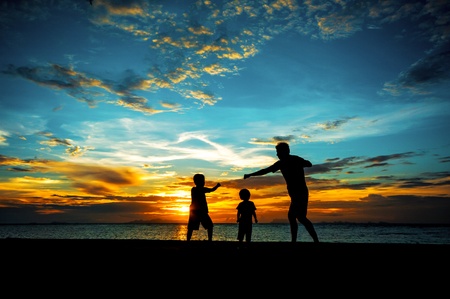 silhouette of family at dusk.の写真素材