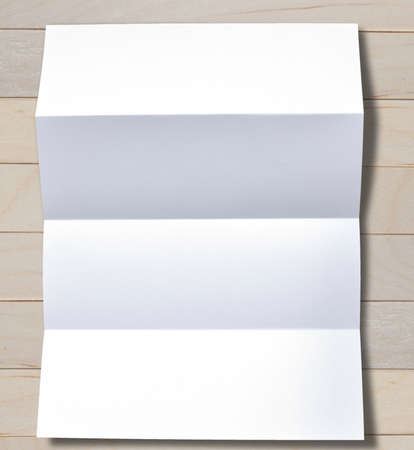Simple folded white blank paper on background.