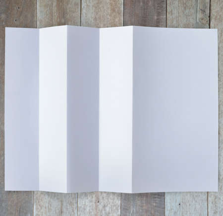 Folded empty white paper on background.