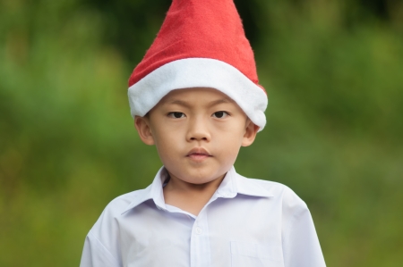 Cute asian boy with red hat and white shirt.