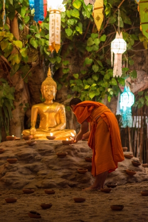 New year festival, Buddhist monk fire candles to the Buddha on Dec 31, 2013 in Phan Tao Temple, Chiangmai, Thailand.のeditorial素材