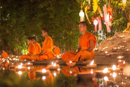 CHIANG MAI, THAILAND - DEC 31: New year festival, Buddhist monk fire candles to the Buddha on Dec 31, 2013 in Phan Tao Temple, Chiangmai, Thailand.のeditorial素材