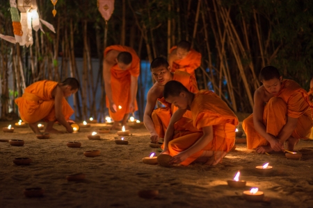 CHIANG MAI, THAILAND - DEC 31: New year festival, Buddhist monk fire candles to the Buddha on Dec 31, 2013 in Phan Tao Temple, Chiangmai, Thailand.のeditorial素材