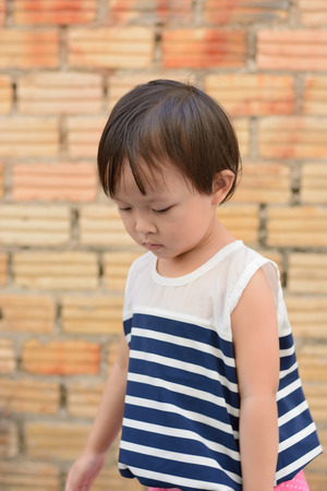 cute small asian girl outdoor action.の写真素材